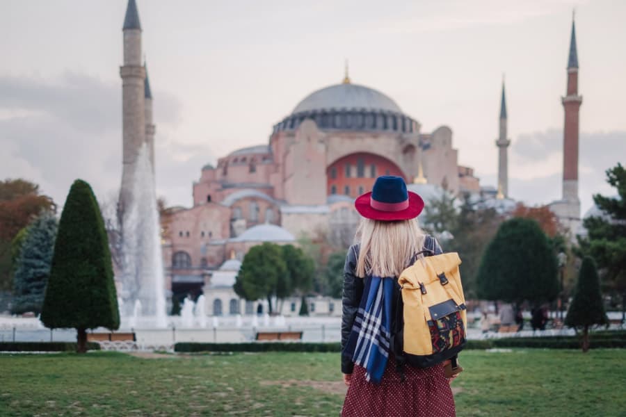 Blonde Girl Standing Across Hagia Sophia In Istanbul. Moving To Turkey Or Living In Turkey